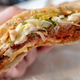 Close-up of half a sandwich filled with plant-based meat and cheese